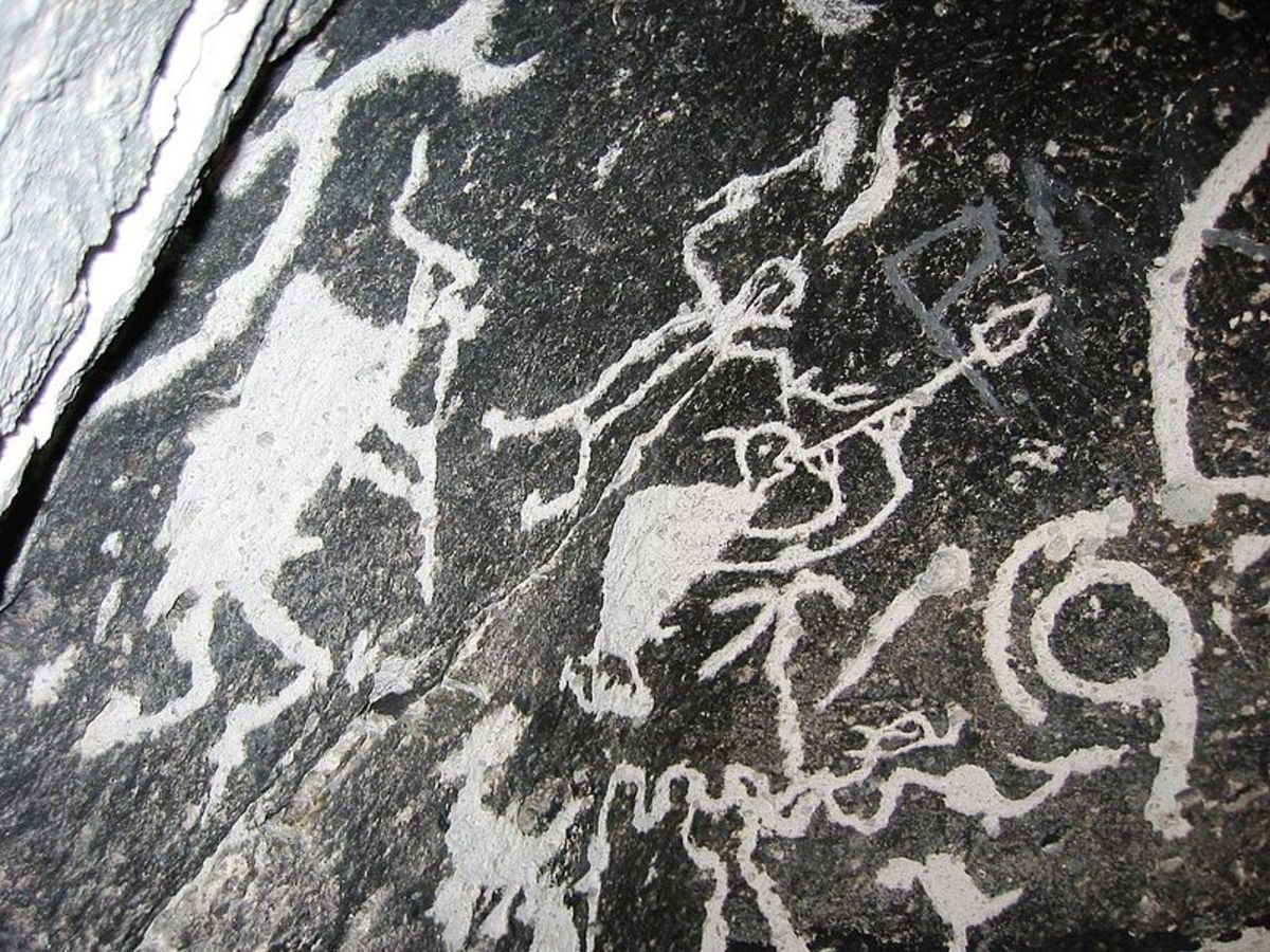 Kokopelli petroglyph. Seen on the left with his typical humpback and flute.