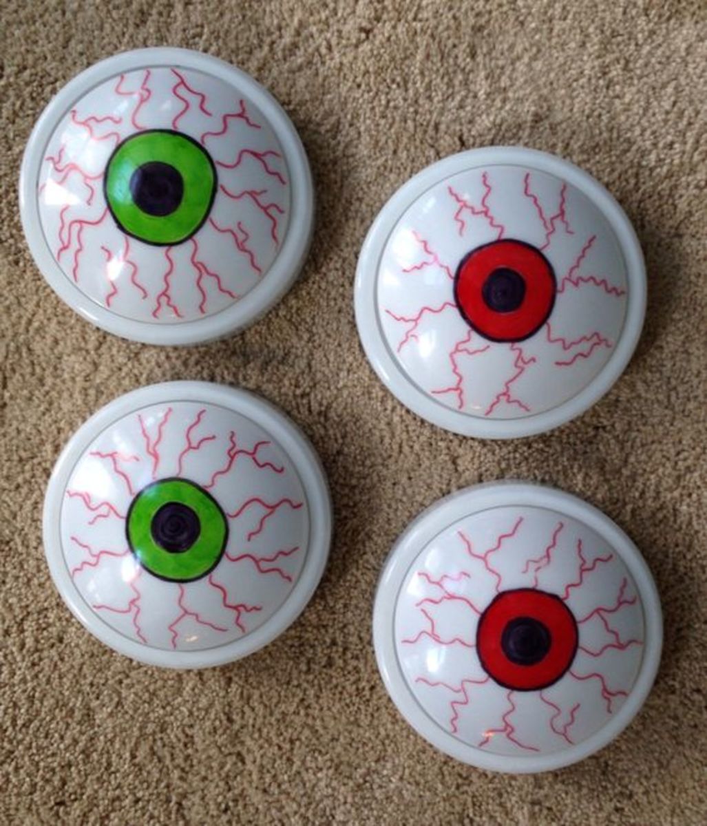 Dollar Tree push lights and sharpie markers make cute/cheap glowing eyes for Halloween decorations.