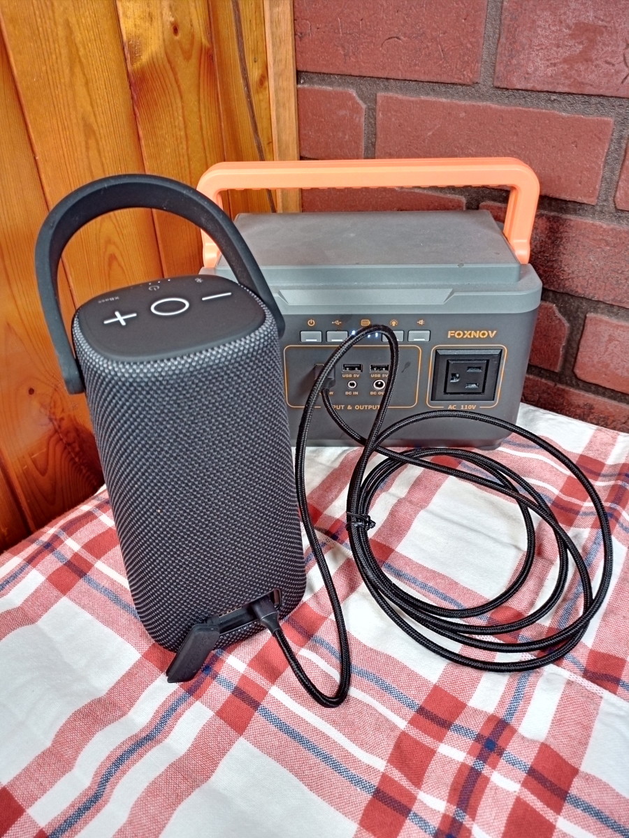 Speaker is being charged by a portable power supply