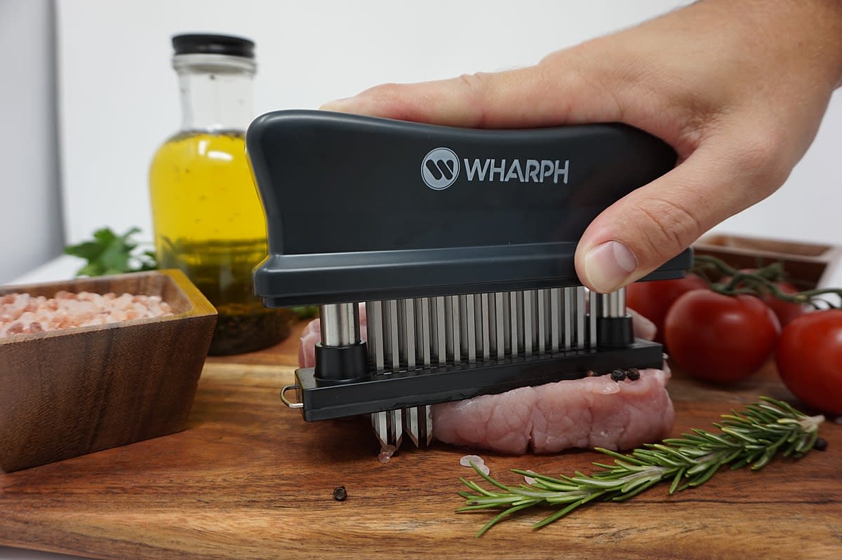 A multiple-prong meat tenderizer in action.