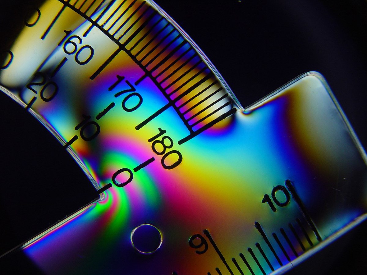 Physics helps us to understand the world in which we live. Here, polarized light reveals stress lines on a bent plastic protractor.