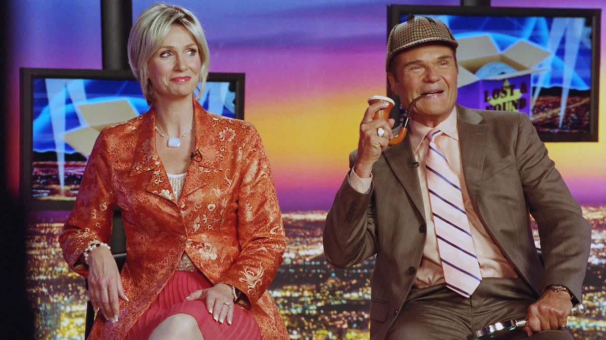 Cindy (Jane Lynch) and Chuck (Fred Willard) investigate everything Hollywood on their show, Hollywood Now, by leaving no stone unturned.