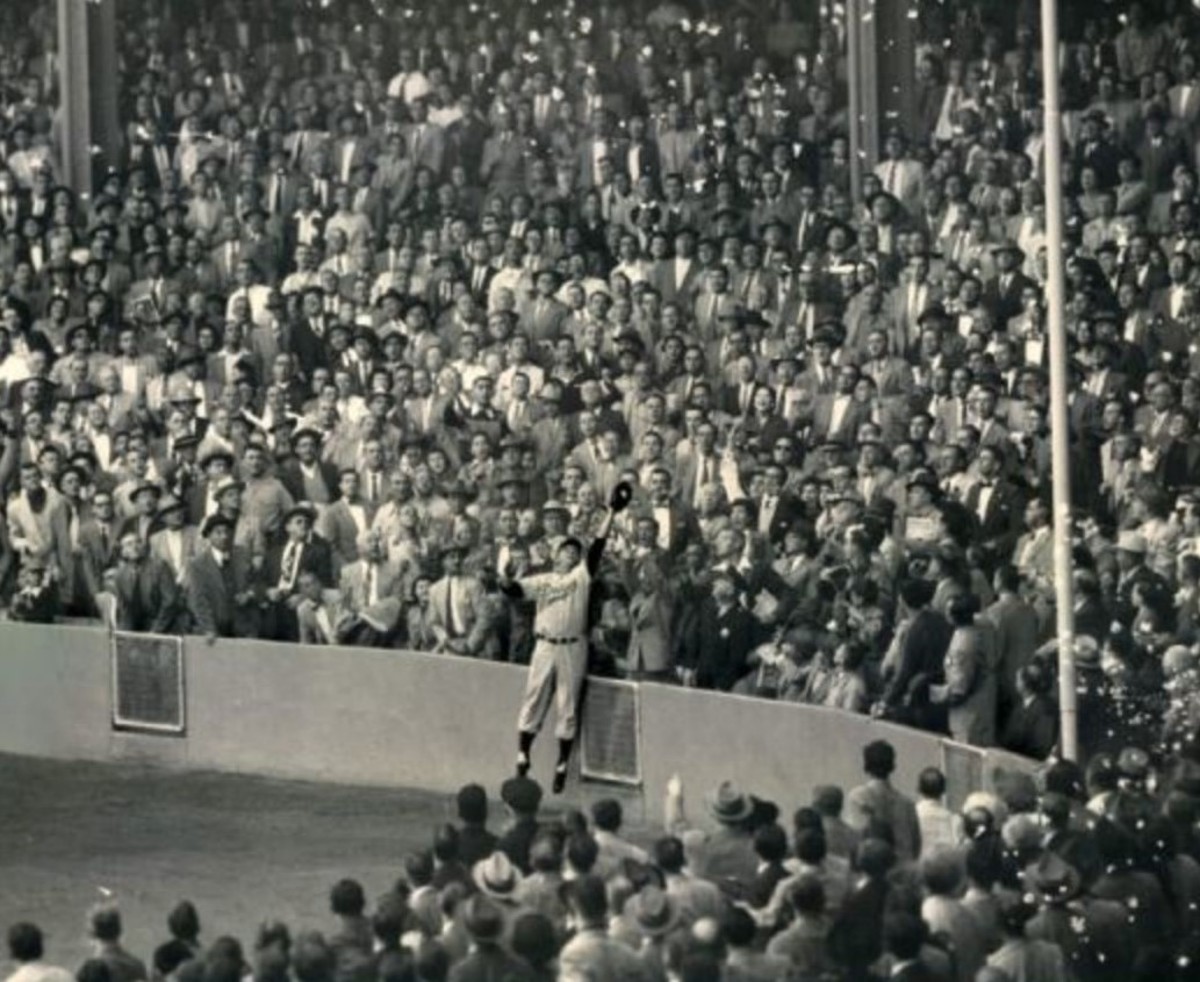 Furillo at Yankee Stadium, 1955 World Series. The wall was much lower then and it was only 299 feet down the line.  Can't believe almost everyone in the crowd is wearing a suit.  