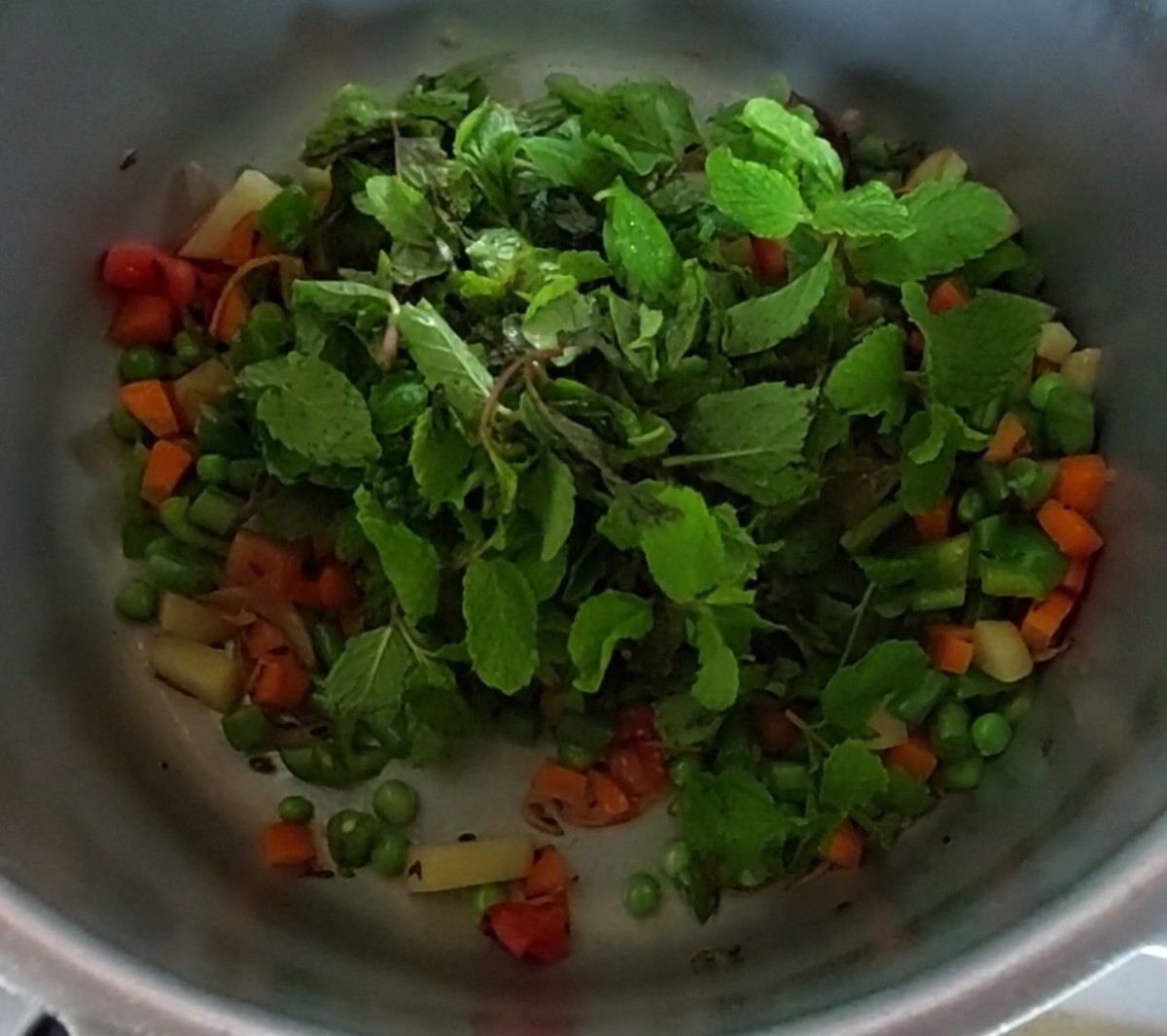 Add 1 cup mint leaves and saute till they shrink.