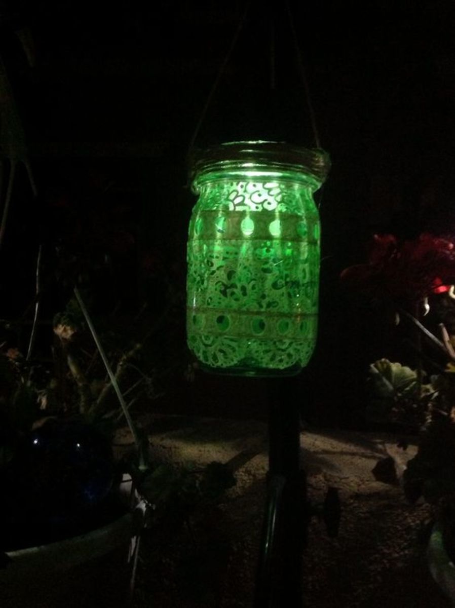 Mason jar tinted & painted & turned into a solar patio lantern, all from the $1 store