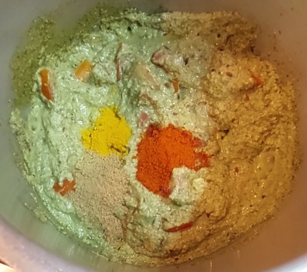 Add 1/2 teaspoon turmeric powder, 1 teaspoon red chili powder and 1 teaspoon coriander powder. Mix well.