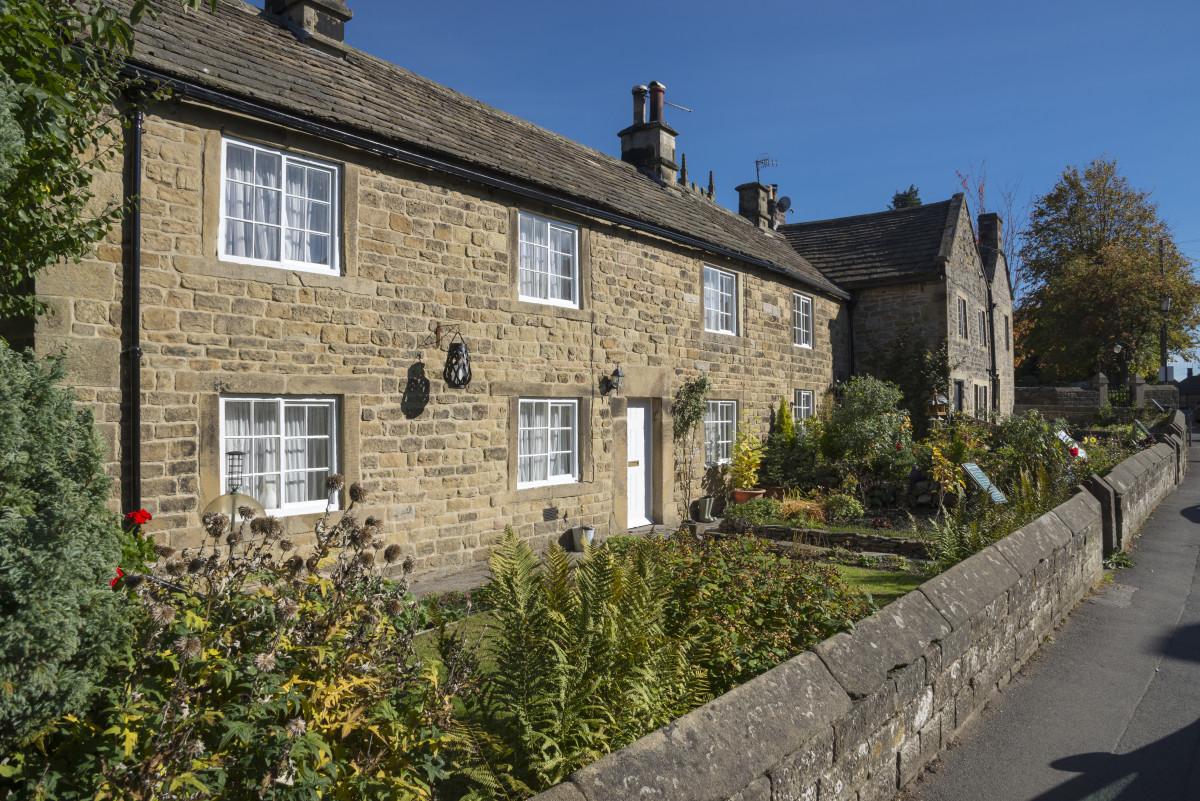 Famous row of cottages in the historic village of Eyam in the Peak District national park. The first victims of a 17th-century plague epidemic died in these cottages. 