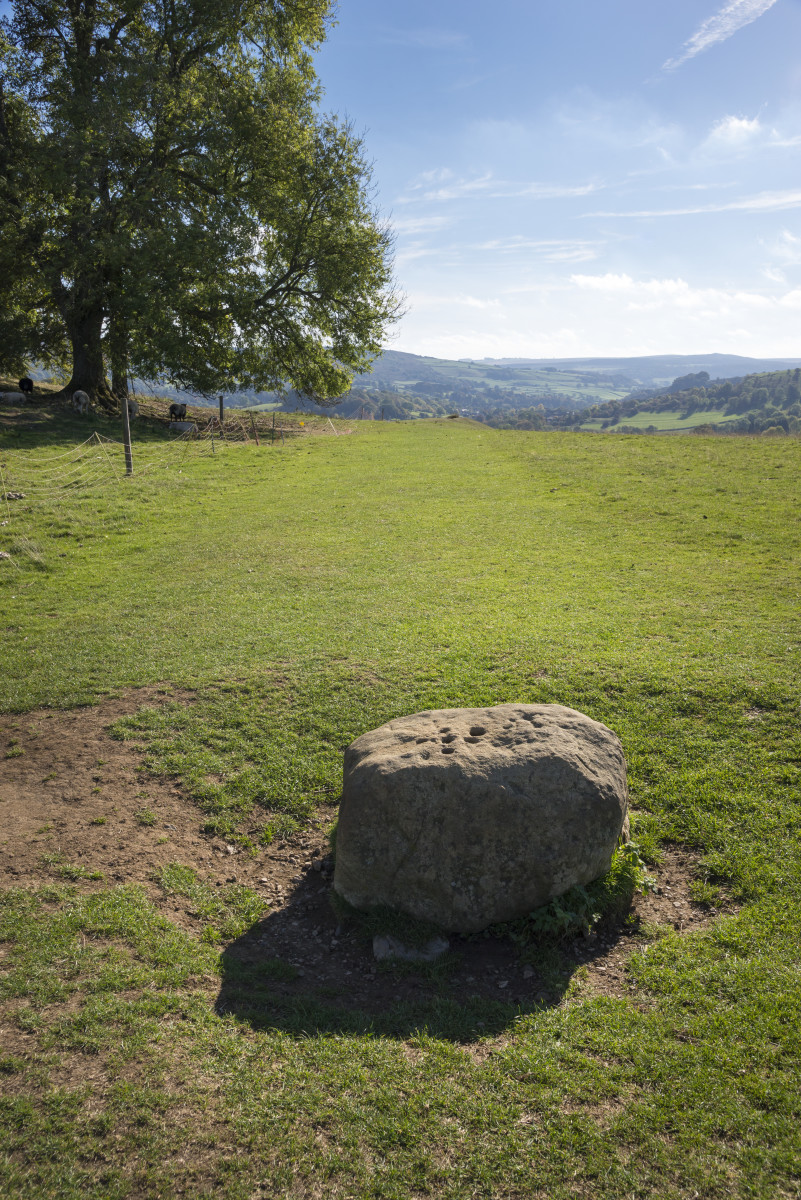 Old stone near the Eyam in the Peak District. Known as the plague village due to an outbreak in the 17th century. The stone has holes in which money was placed in vinegar as payment for goods left for the villagers.