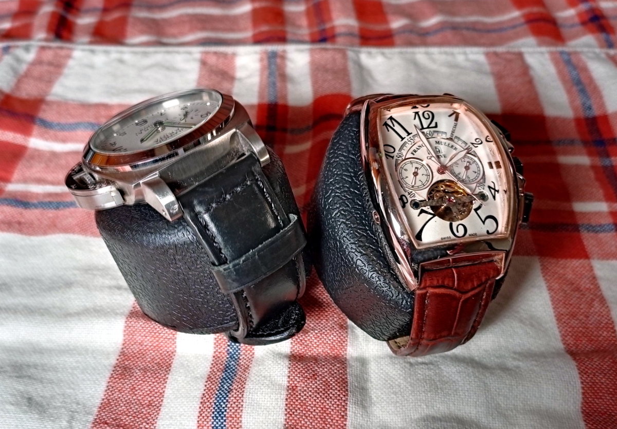 A large and an odd-shaped watch have been fastened to the cushions