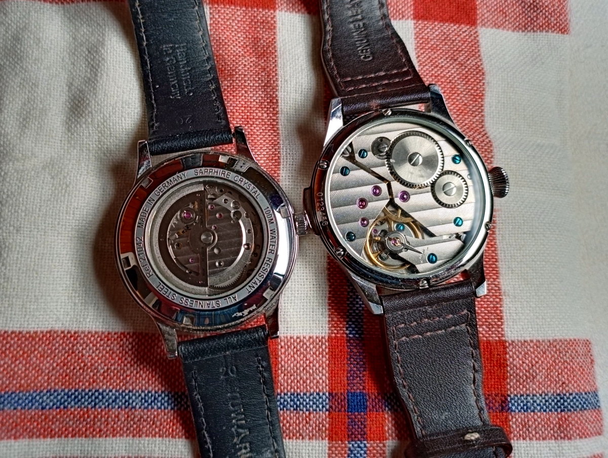 Two mechanical watches.  The timepiece on the right is not an automatic and cannot be wound by the watch winder