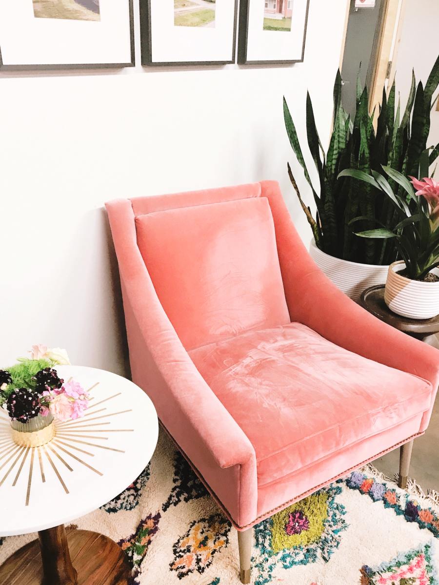 A pink accent can help a room get a more positive feel to it. Pink is generally associated with positive words like compassion, kindness, innocence, friendliness, and love.