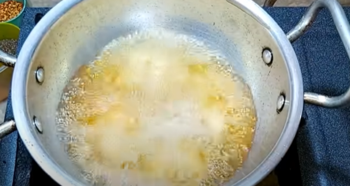 Using a tablespoon, take small portions of the mixture and drop them one by one into the hot oil to fry. Do not crowd the pan as the chicken needs enough space to properly cook.