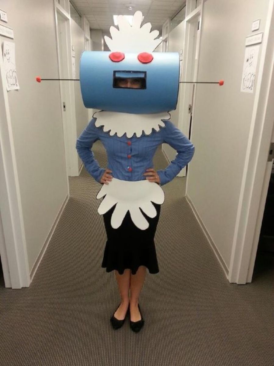 Rosie the Robot from the Jetson's. Just two round pieces of Styrofoam, two light blue posters, a couple dowel rods, felt, foam (for apron and cap), and a sharpie. The buttons were pompoms hot glued to bobby pins.