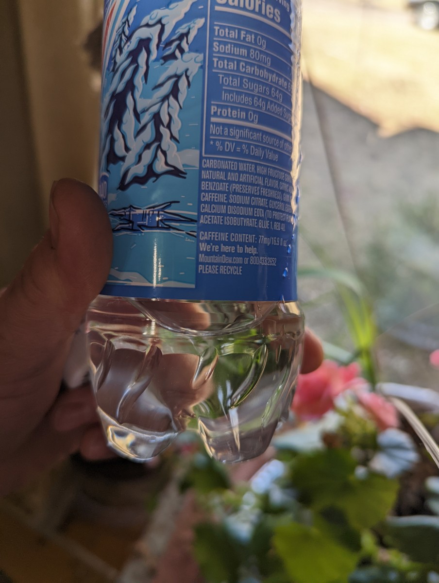 plant-watering-using-a-cut-off-bottle-for-watering-funnel