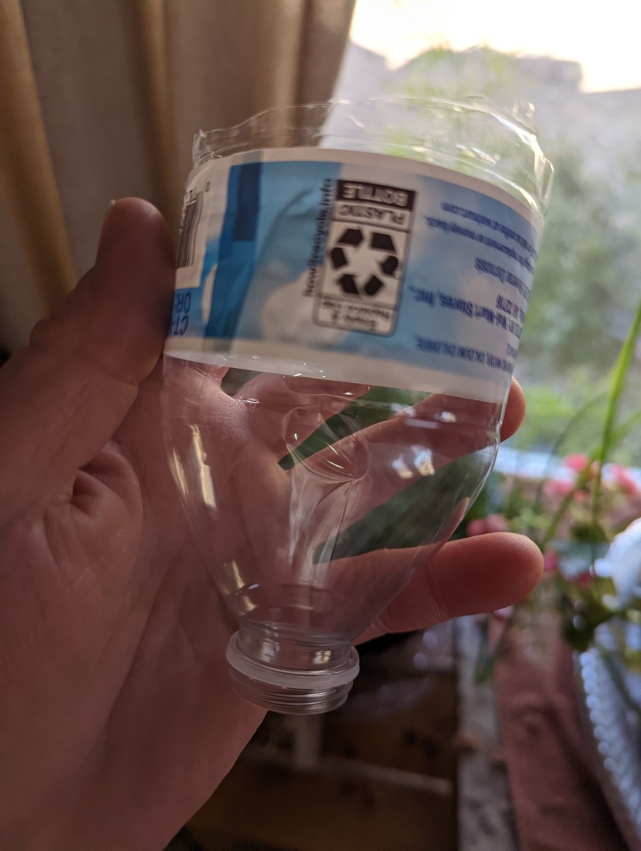 plant-watering-using-a-cut-off-bottle-for-watering-funnel