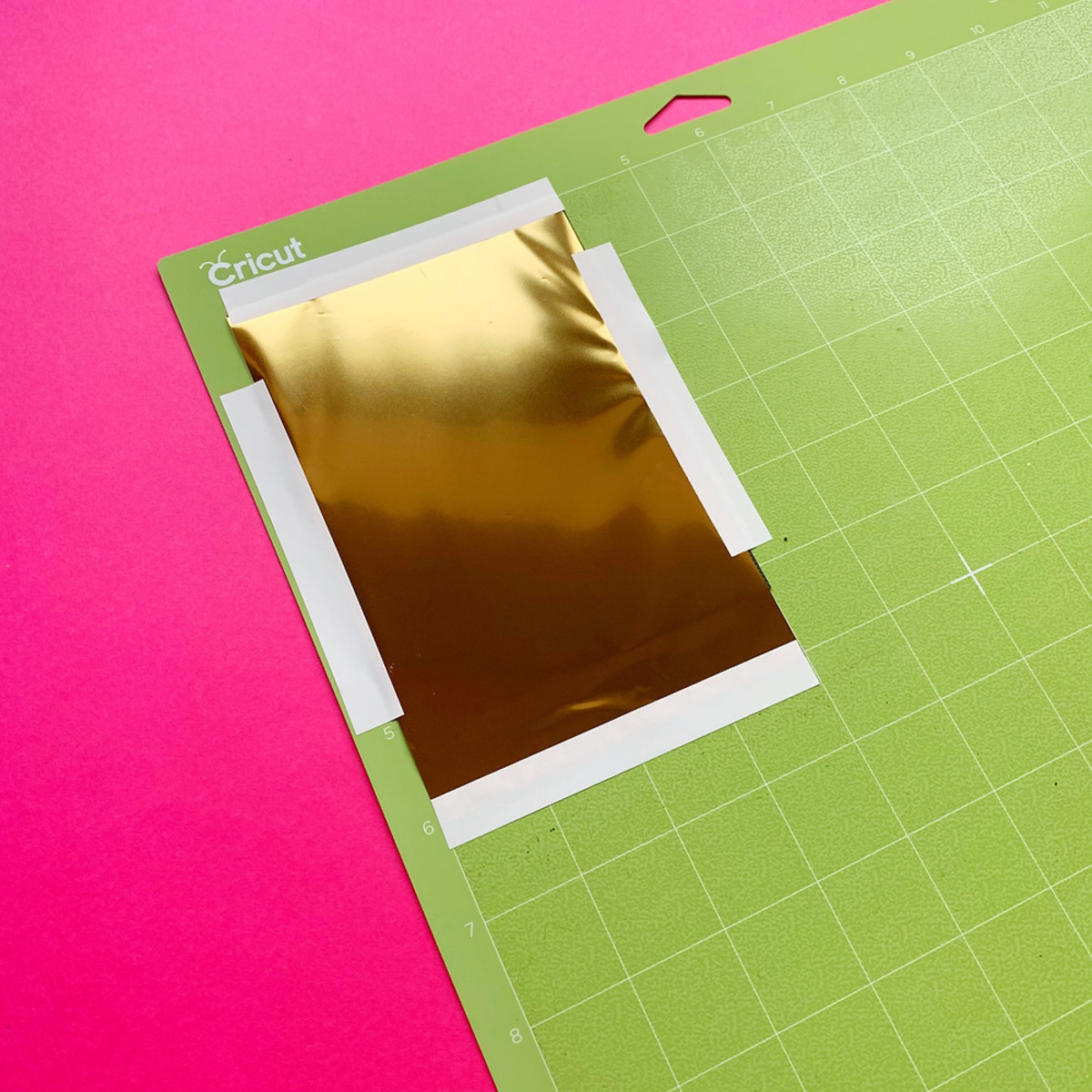 Correct way to place foil on the mat: The foil should be placed over the cardstock and then taped onto the mat.
