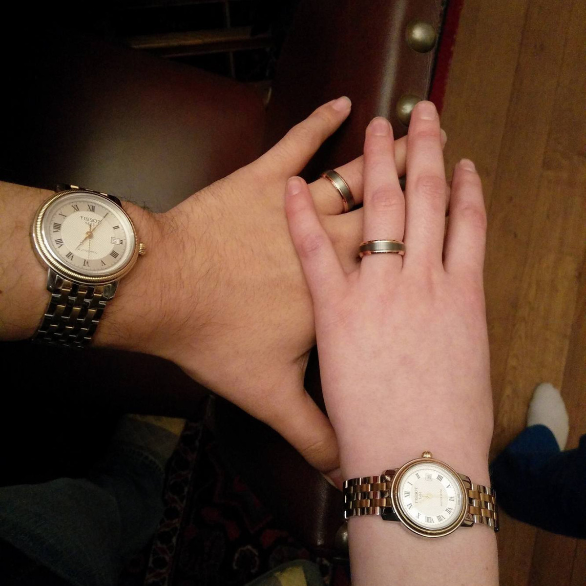 A picture of our wedding rings and matching watches that we included