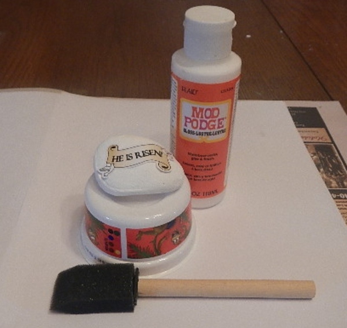Apply several thin coats of Mod Podge to the paperweight. Use acrylic spray sealer to finish the project. 