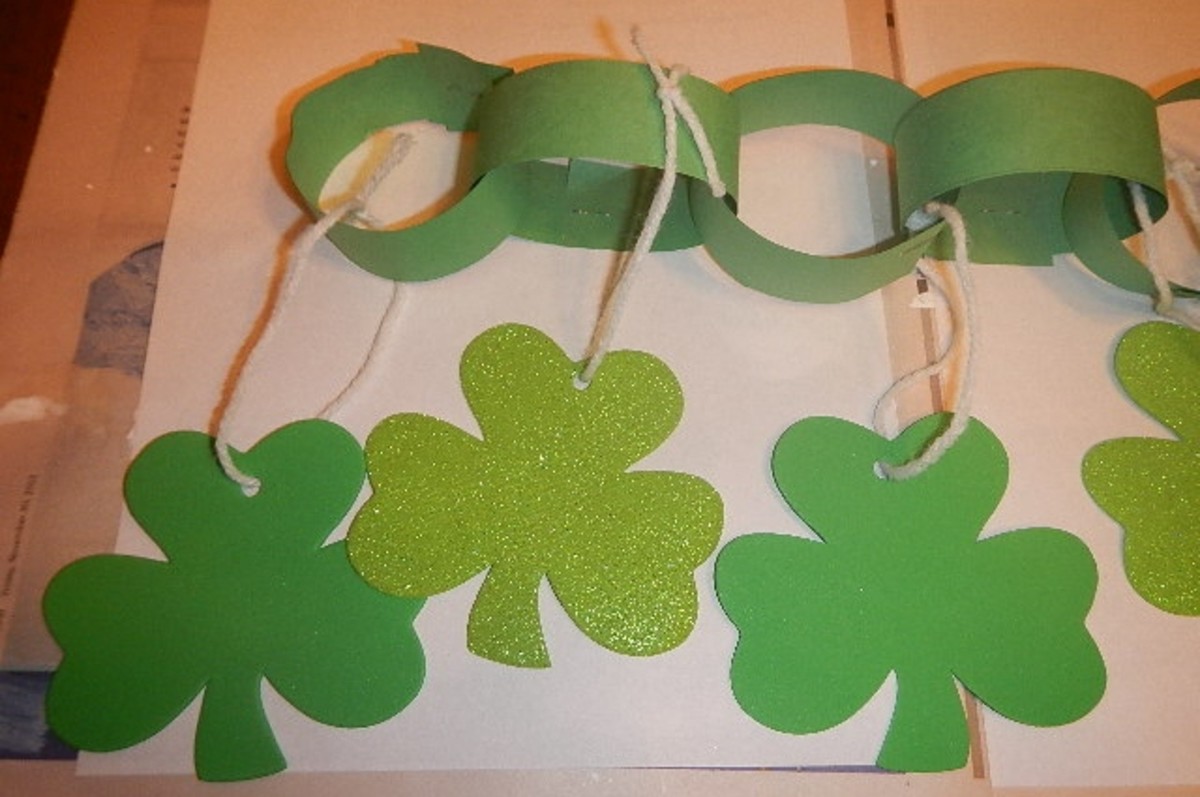 Make paper chains and then use yarn to tie the shamrocks to the individual chains. 