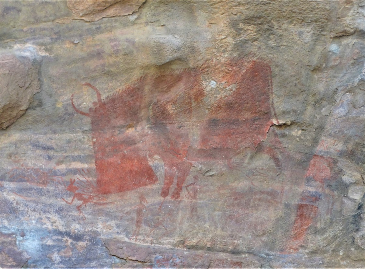 Pre-historic cave painting showing a huge bison with few men, possibly hunters; Bhimbethka; Madhya Pradesh, India