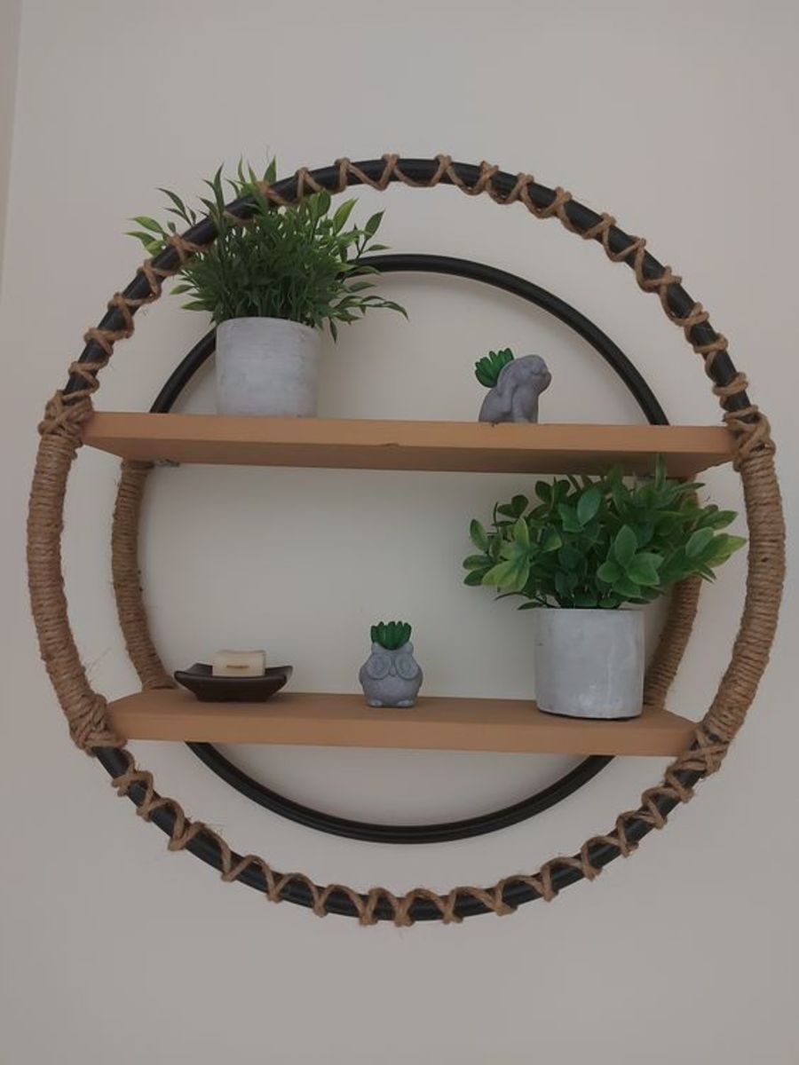 Hula hoop shelf made with hula hoops, jute, wood, and screws