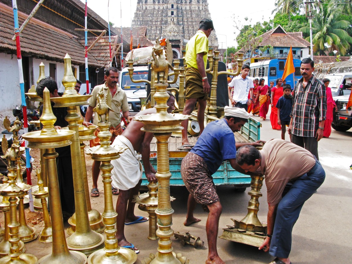 Workers load holder for oil lamps made of brass on a car at Hindu Temple Sri Padmanabhaswamy on January 06, 2008, in Trivandrum, India