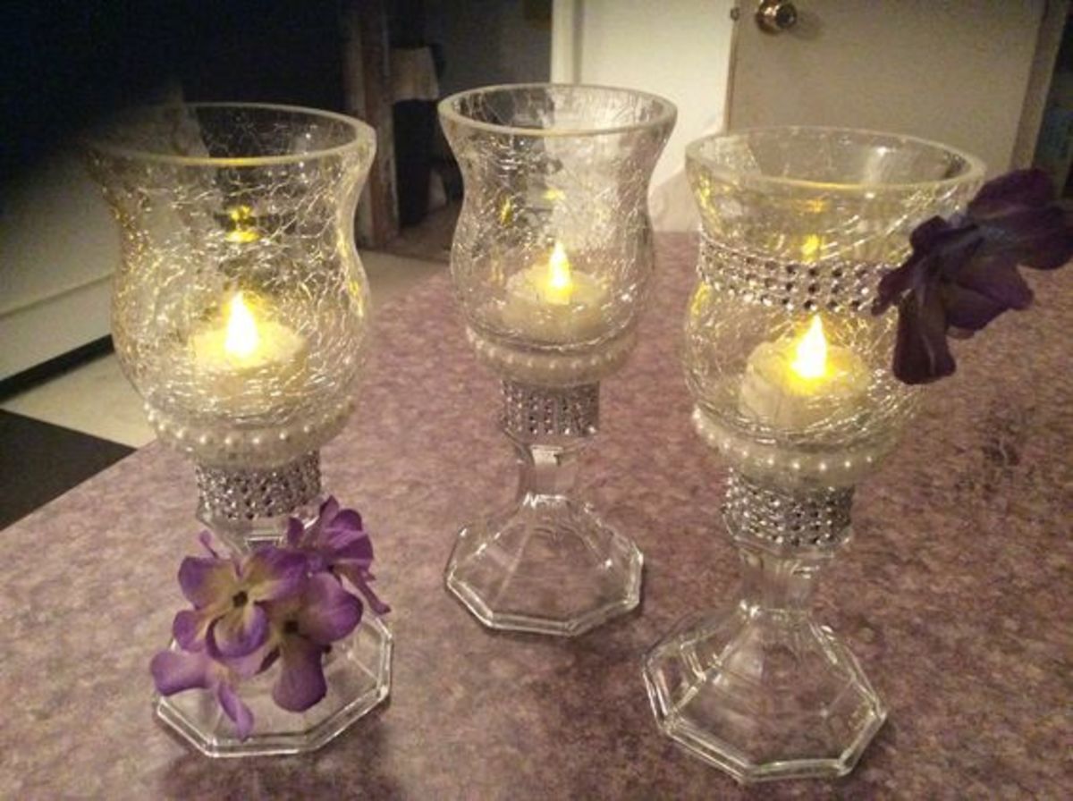 candle holders from the dollar store, glued together. Flowers and pearls  added with hot glue.