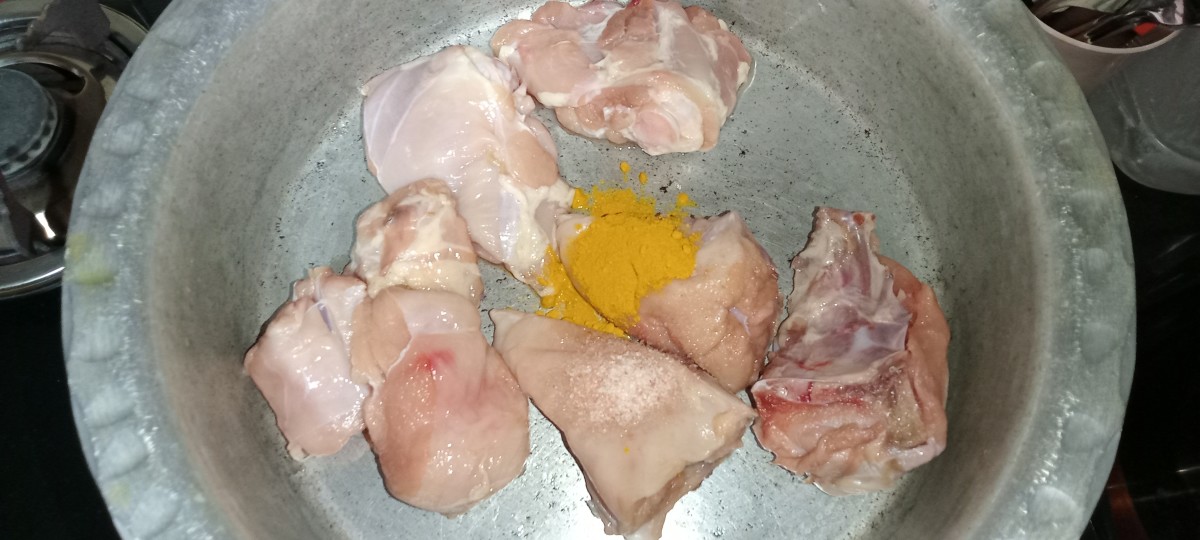 Add salt and turmeric powder to the chicken.