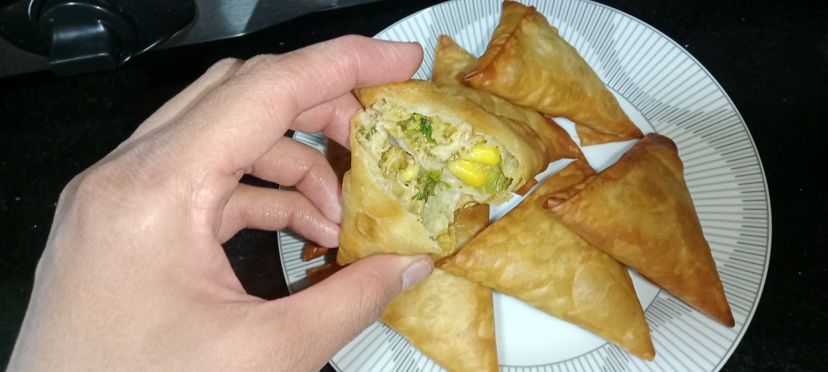 Close-up of the yummy filling of a  crispy samosa.