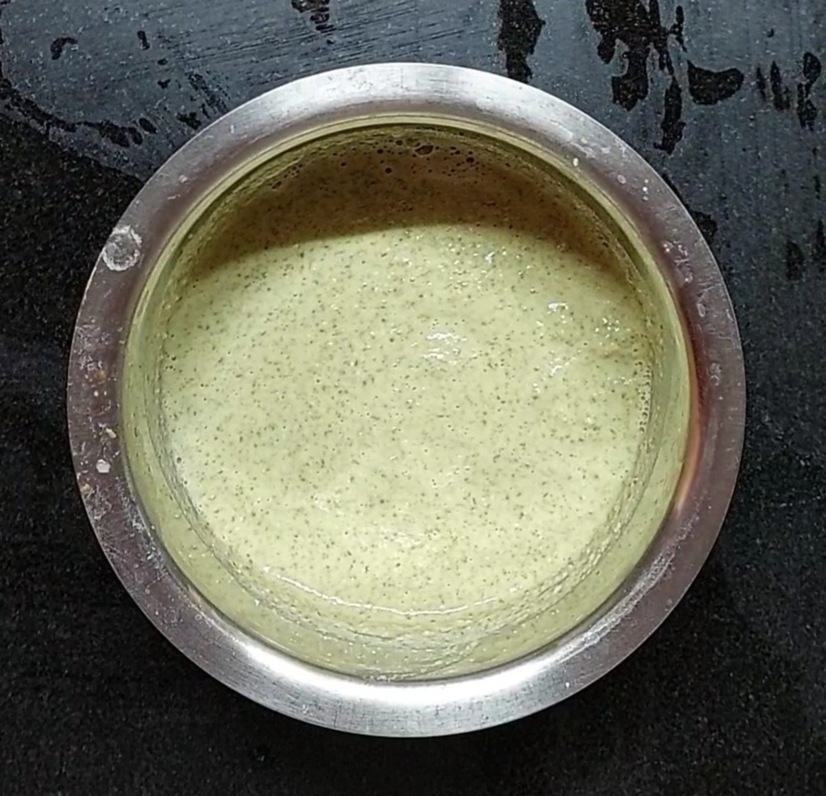 Transfer the ground paste to a vessel. Add salt to taste. Mix well and add water to adjust the consistency. The batter should be medium thick. Green gram dosa batter is ready. Set aside.