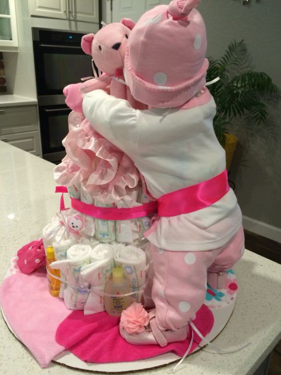 Diaper Baby hugging ready bear with a diaper cake