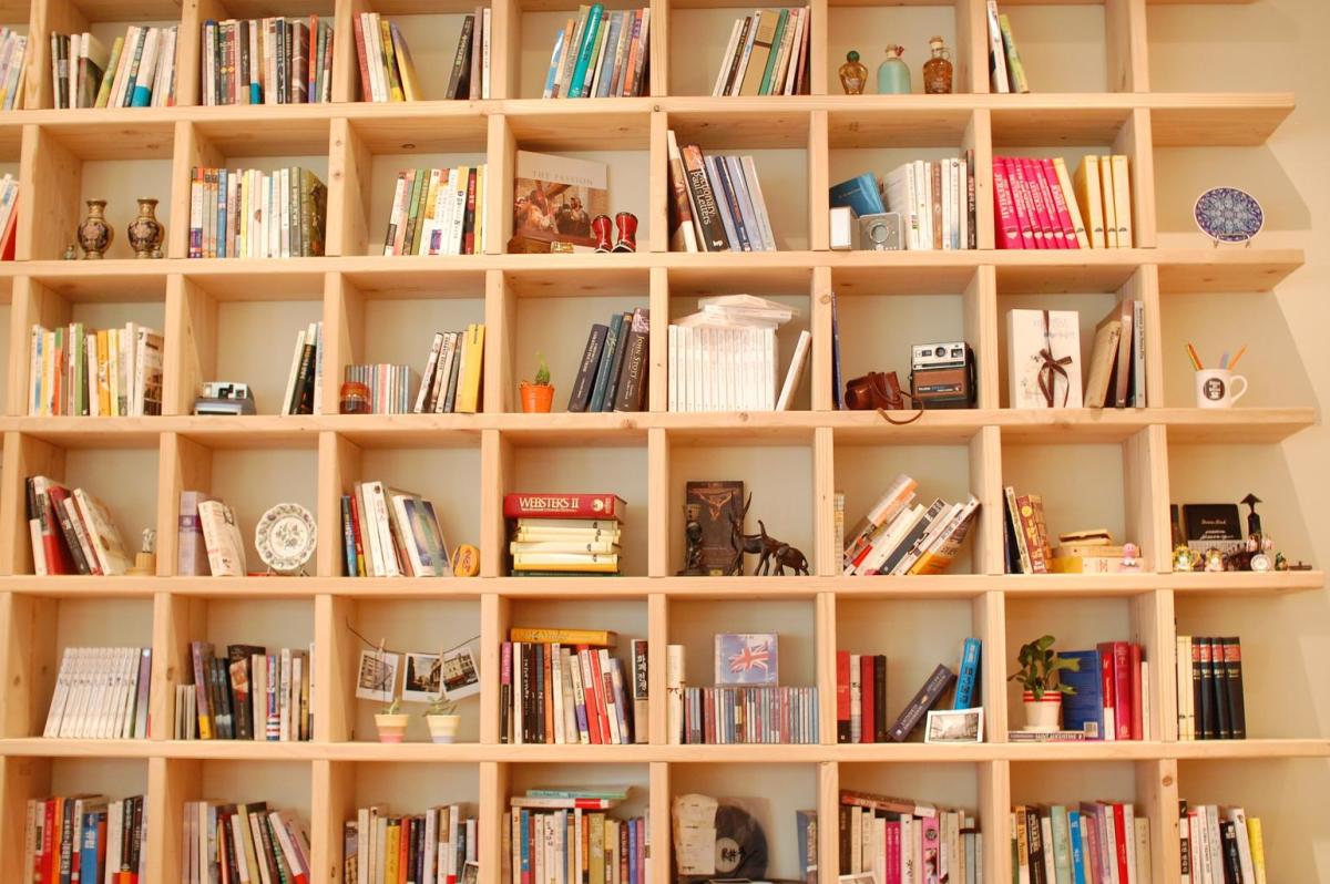 A bookcase may be as large as you wish, space permitting. It may also be unconventional in shape and cover an entire wall for trinkets as well as books.
