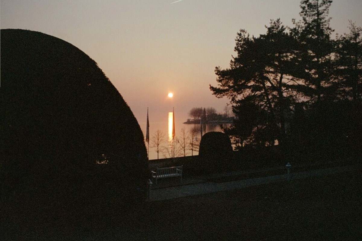 Laussane by the Lake, Switzerland - It was a family trip, after playing the mini golf, we walked through the lake promenade. The sun started to sleep after a warm beautiful day. Sitting in a picnic bank admiring the beaty of the sunset.