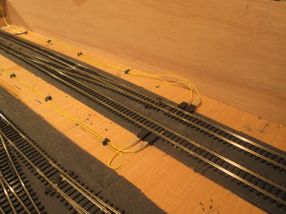 ... And lead through cable clips to the Power Terminals either side of the Up and Down Main lines in the fiddleyard