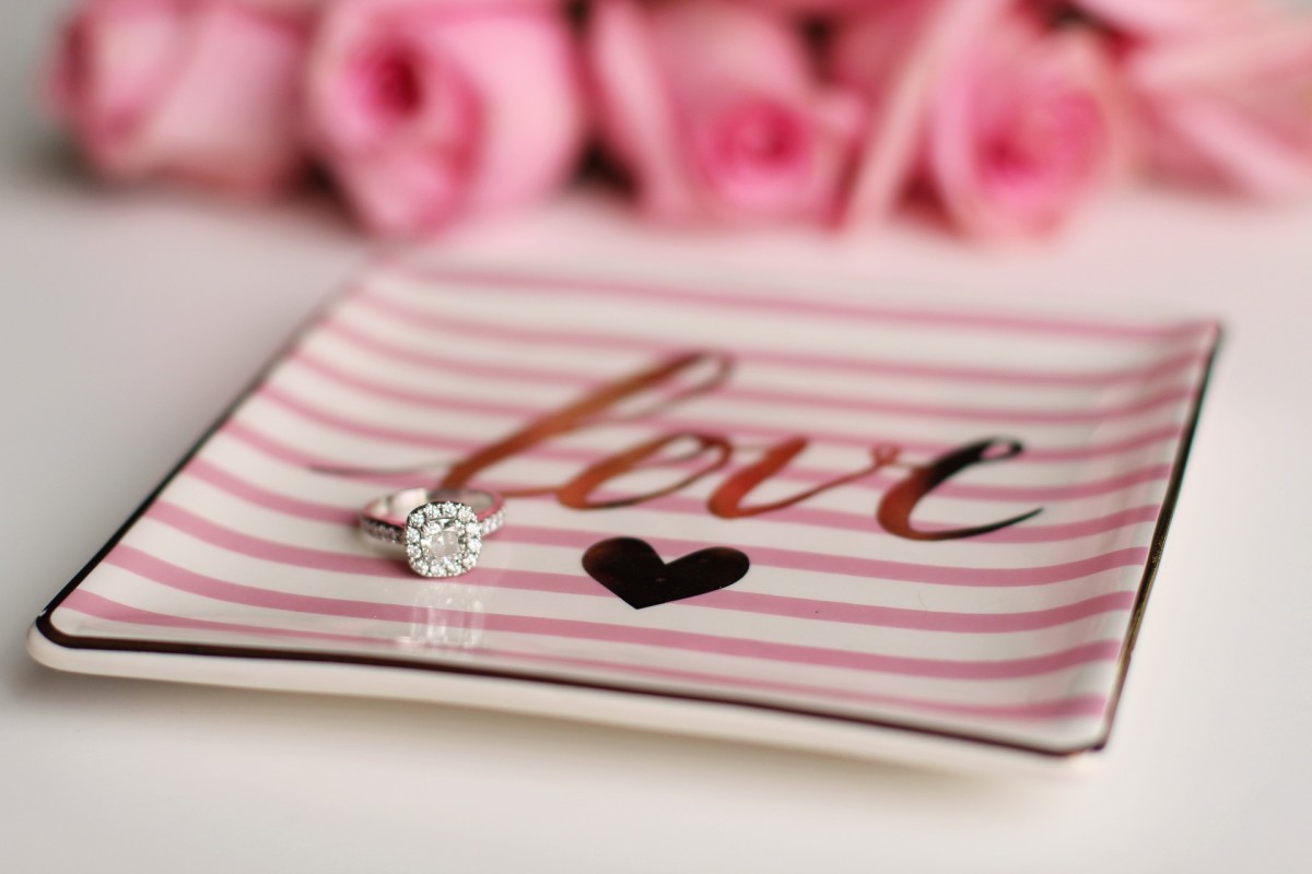 A dish labeled with the word Love and a heart help to display rings. 