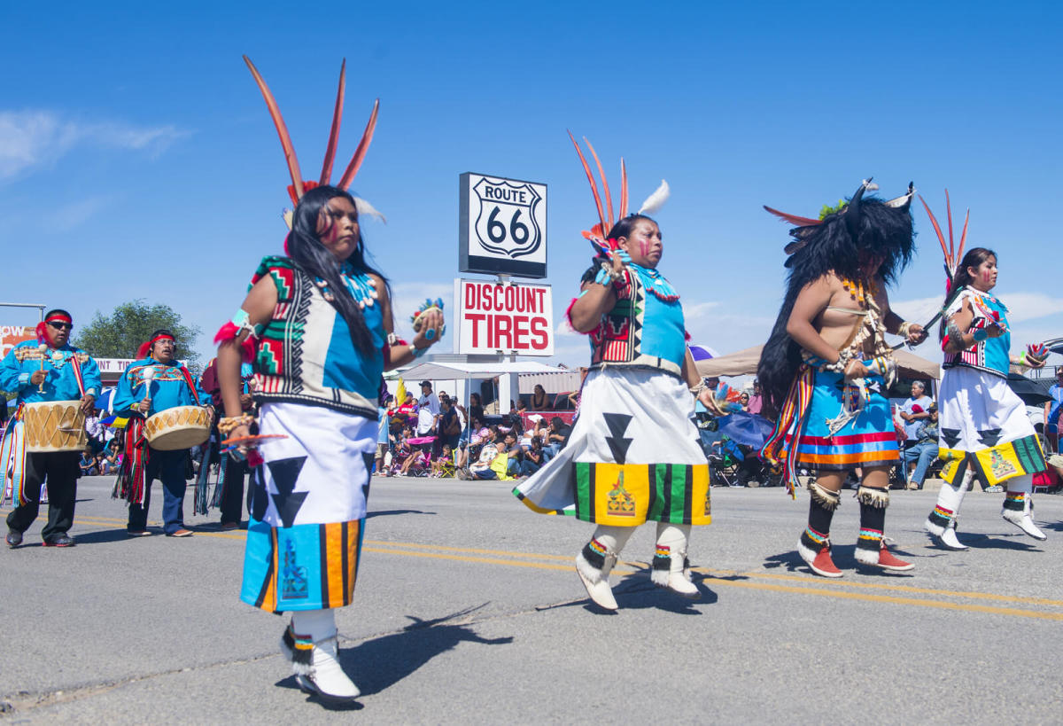 A group of Native American Indians with their traditional outfits on parade 