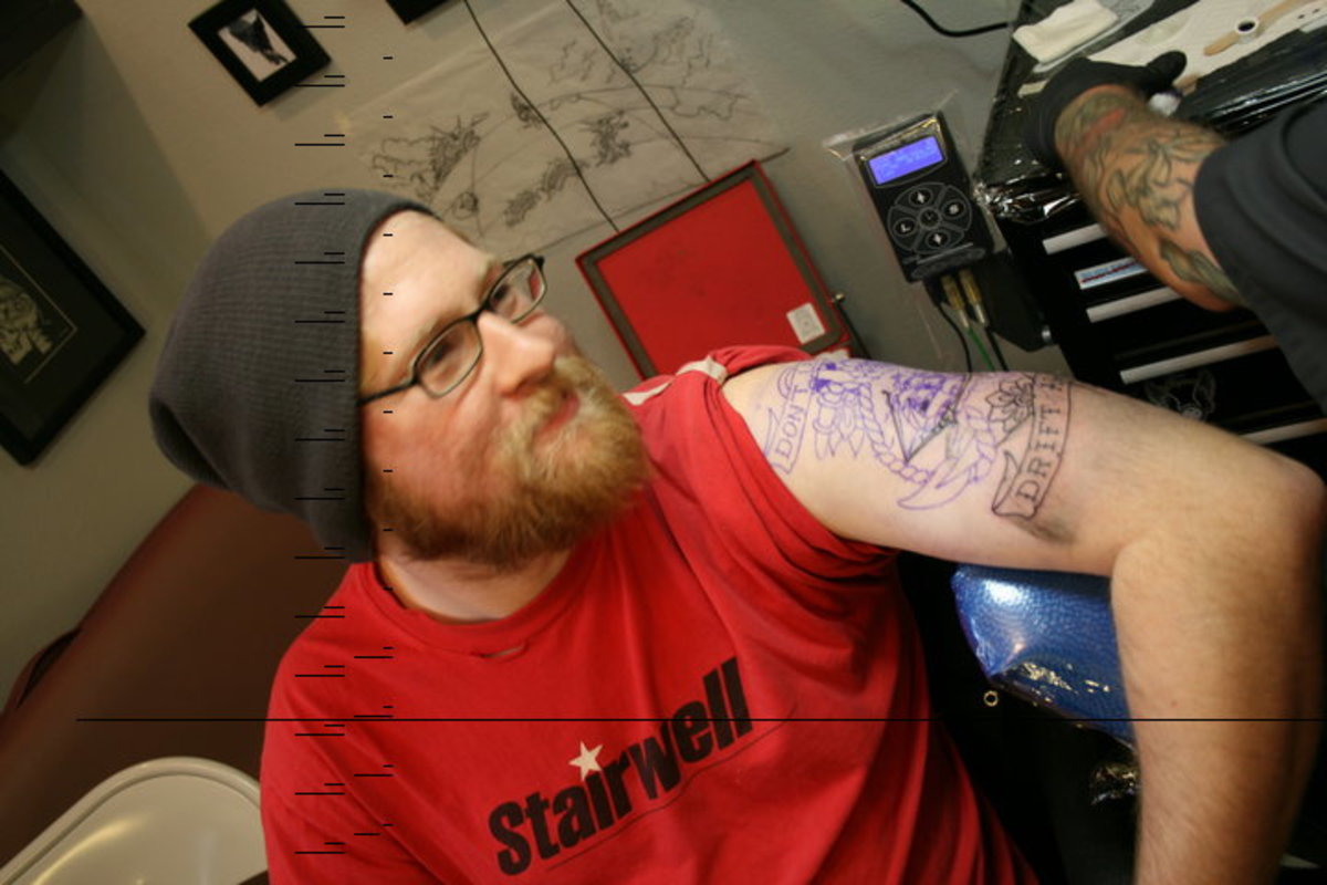 Me getting one of my tattoos. The purple ink is from the transfer paper, which the artist then traces using the permanent tattoo process.