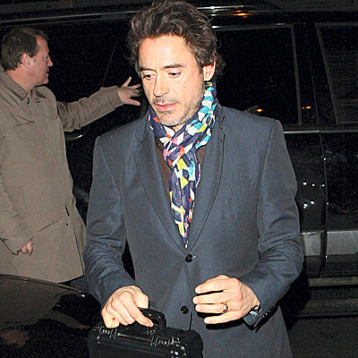 Roberty Downey Jr in a colorful pashmina and grey blazer suit coat