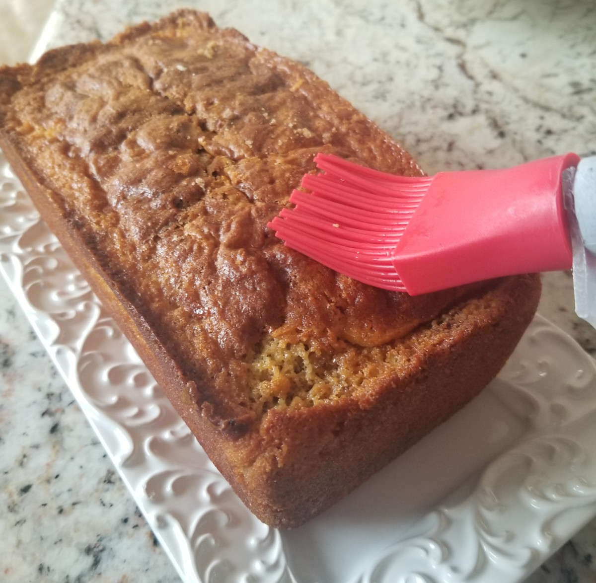 Brushing a thin glaze on a cake makes it easy to evenly distribute the glaze. Photo by Abby Slutsky