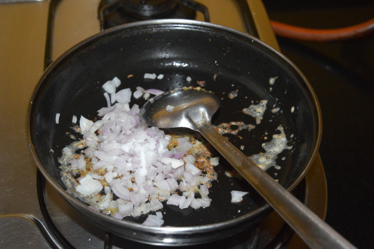 Step two: Add chopped onions and some salt. Saute until the onions become transparent.