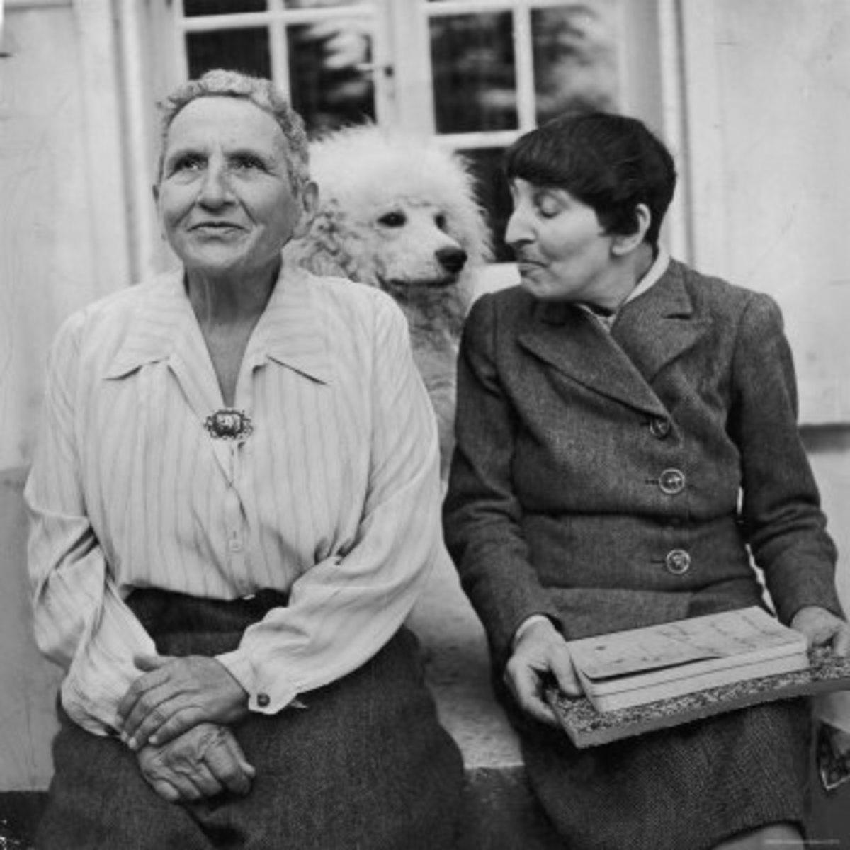 Gertrude Stein with Alice B. Toklas and their beloved dog.