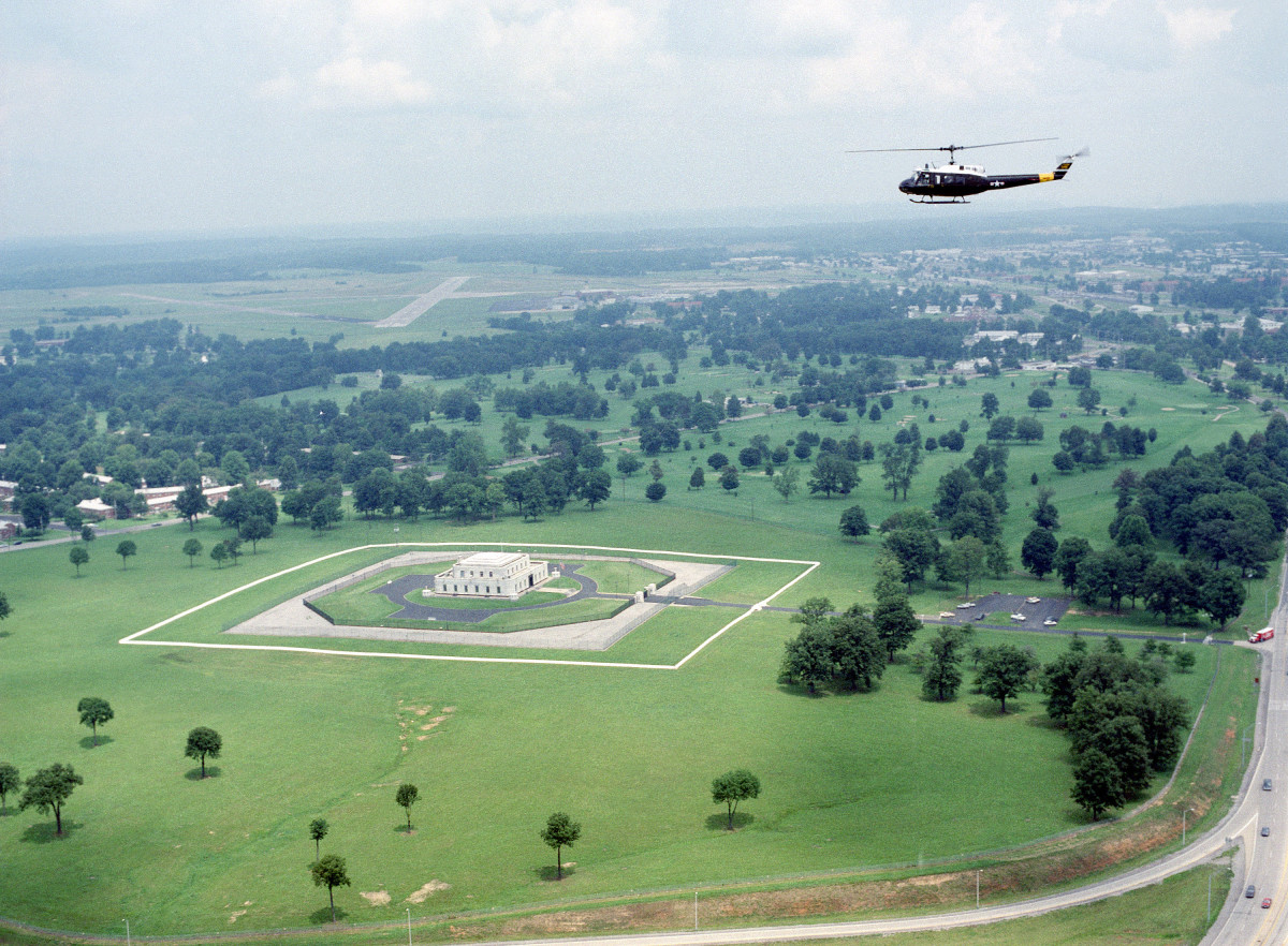 An UH-1 Iroquois helicopter flies over the US Gold Bullion Depository.