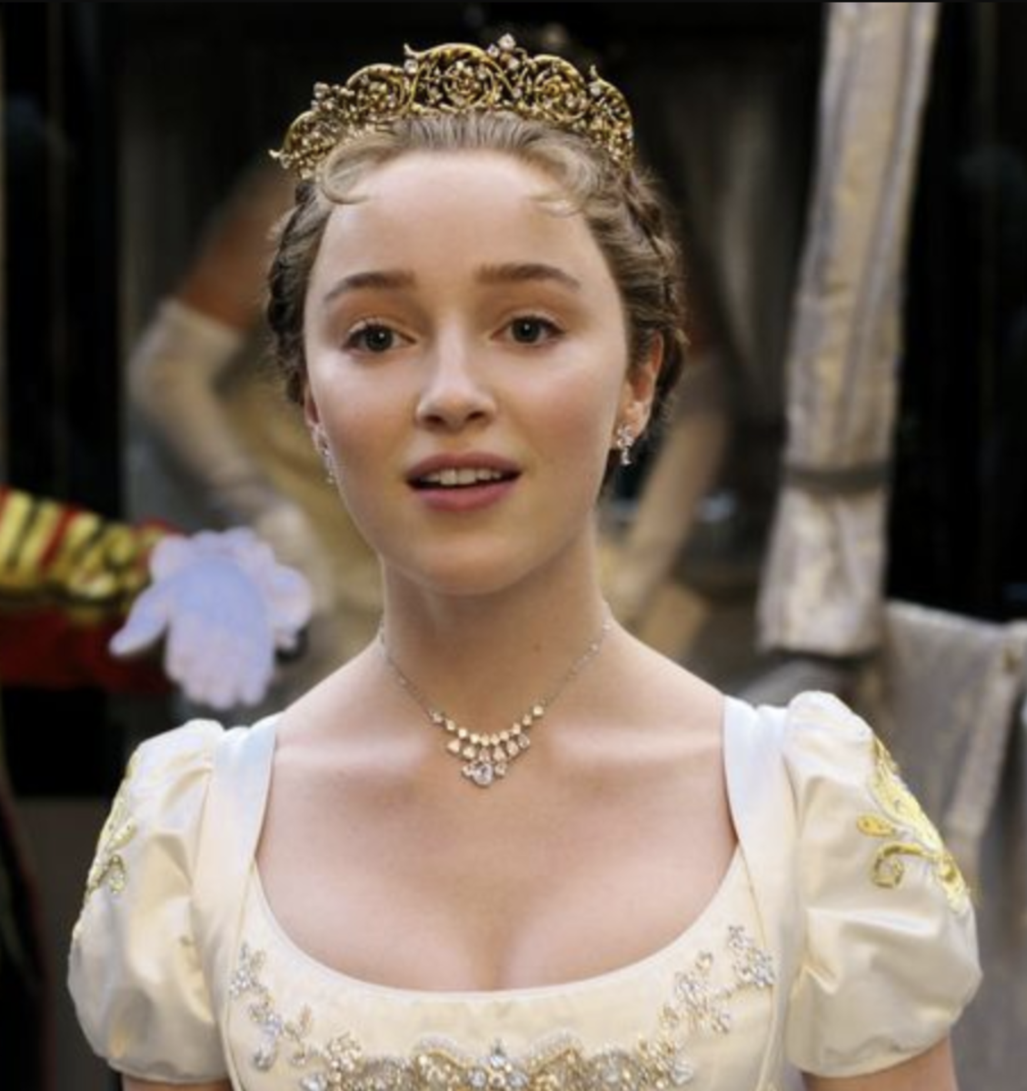This is Phoebe Dynevor as Daphne Bridgerton from the series "Bridgerton," which is known for its sumptuous costume design.