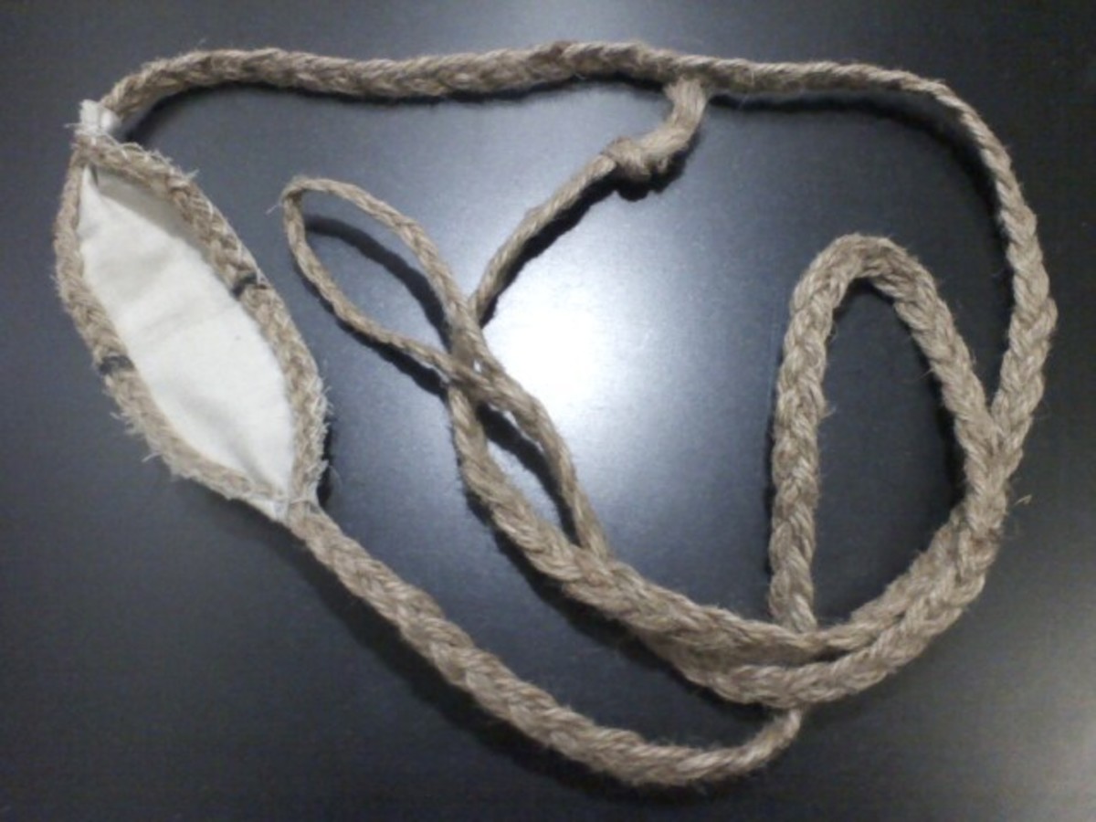 This slingshot is a 4 strand round braided Apache with cotton twine and a leather pouch.