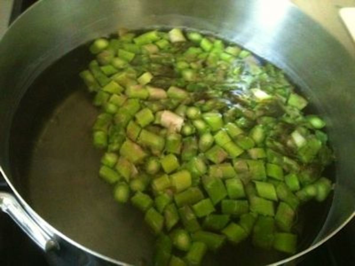 Blanch diced fresh asparagus in boiling water.