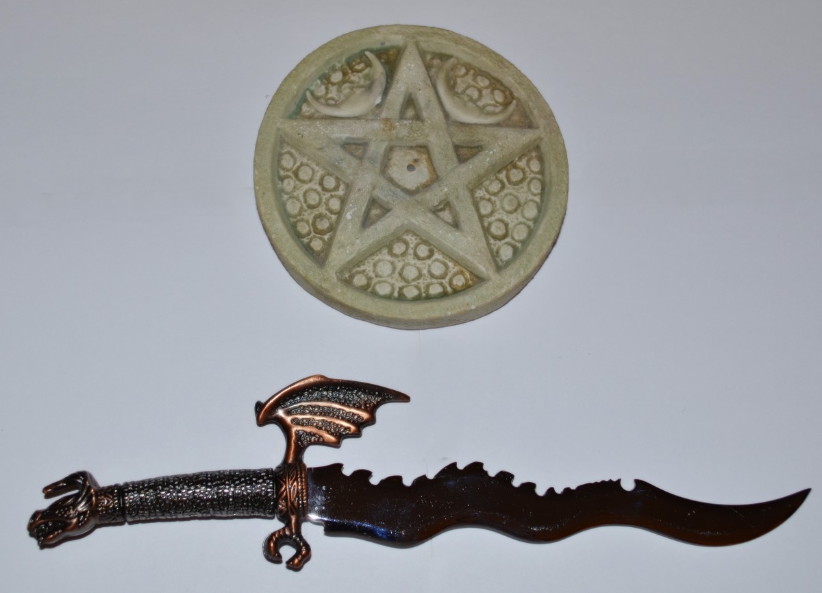 My athame (ritual knife) and pentacle altar tile. 