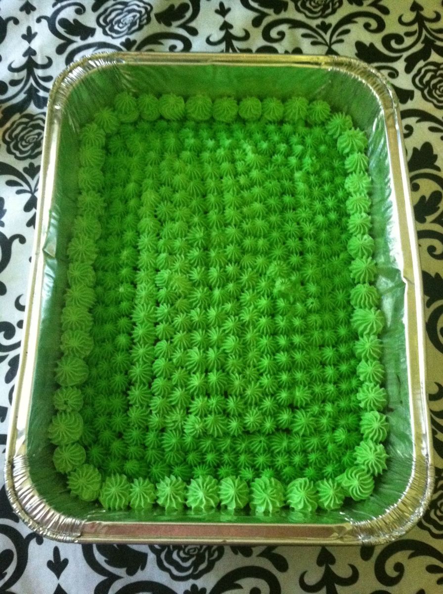 I used a large decorating tip to create a grass-like appearance across the entire sheet cake.