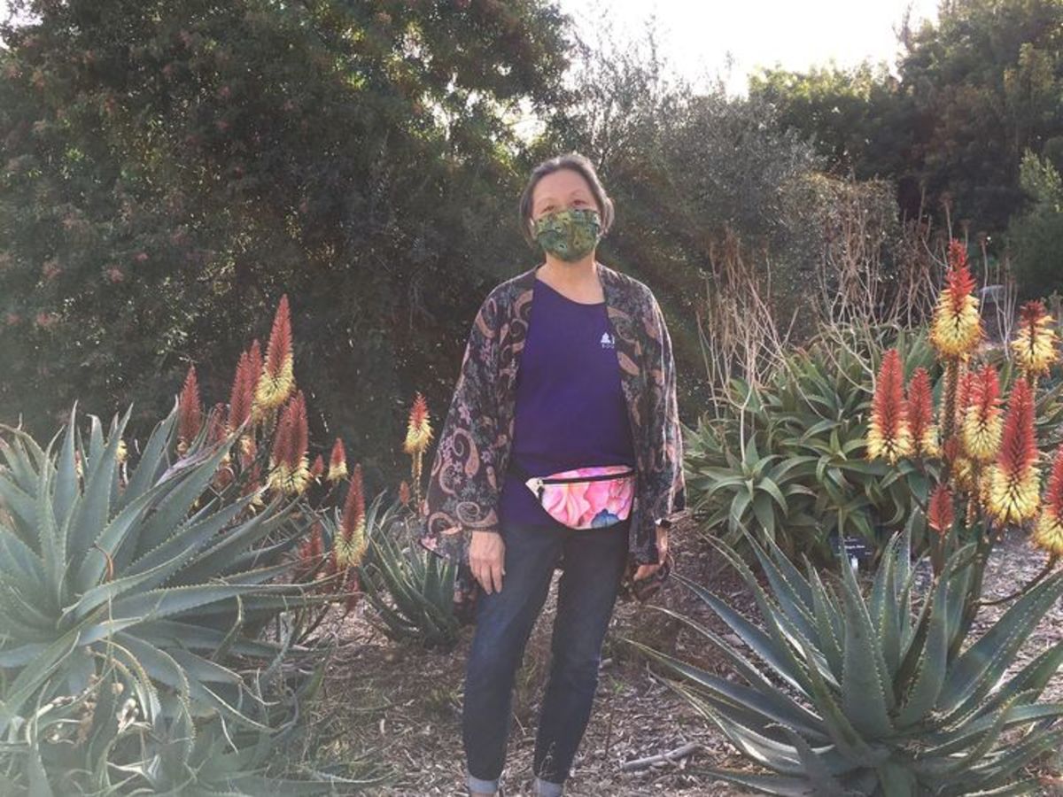 My dear friend showing off her fanny pack with my watercolor roses on it from Redbubble