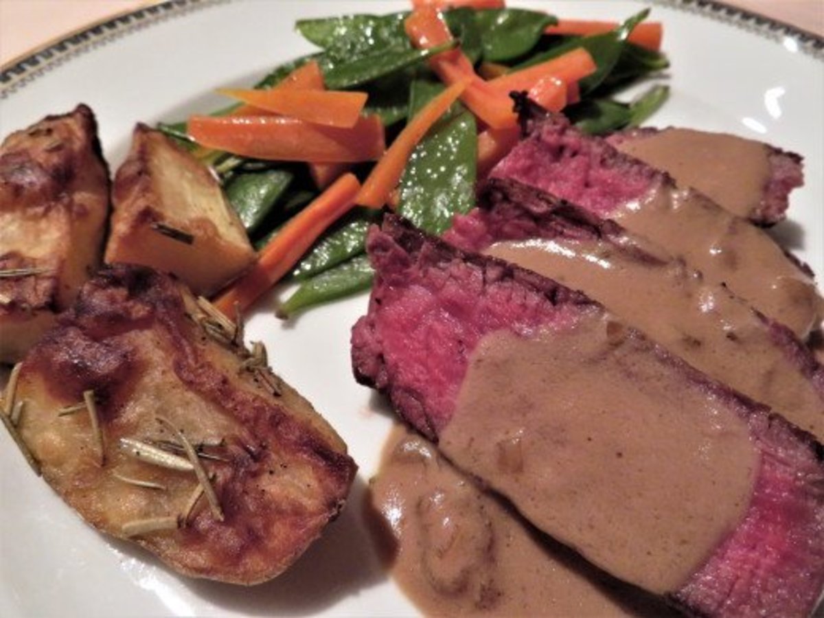 Madeira sauce over steak with accompanying vegetables