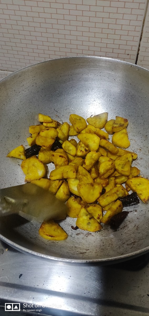 Getting cooked in medium flame,Raw banana dry veggies